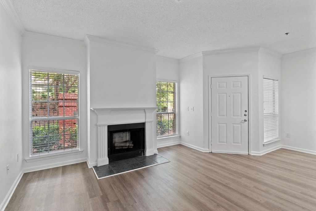 A white room with a fireplace and a door.