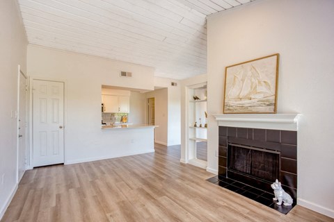 a living room with a fireplace and a painting on the wall