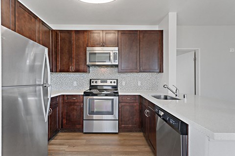 a kitchen with stainless steel appliances and wooden cabinets