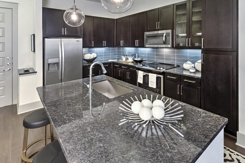 a kitchen with granite counter tops and stainless steel appliances
