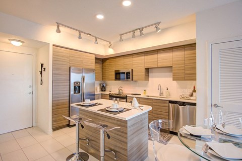 a kitchen with a table and a refrigerator