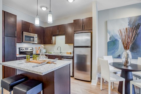 a kitchen with stainless steel appliances and a marble counter top