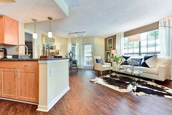 Windsor Oak Creek- Kitchen and living room with a couch and a table in Fairfax VA