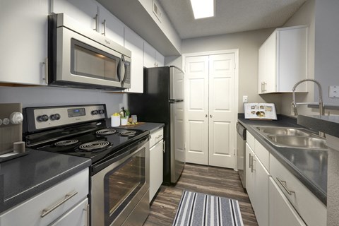 a kitchen with stainless steel appliances and white cabinets