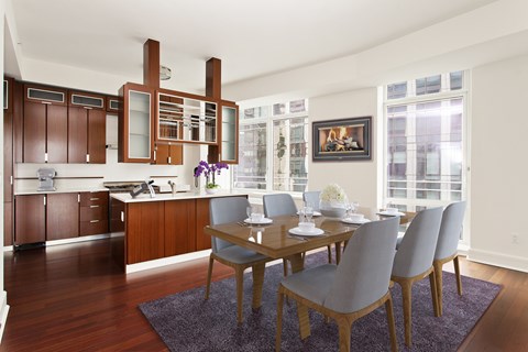 A modern kitchen with a dining table set for four.
