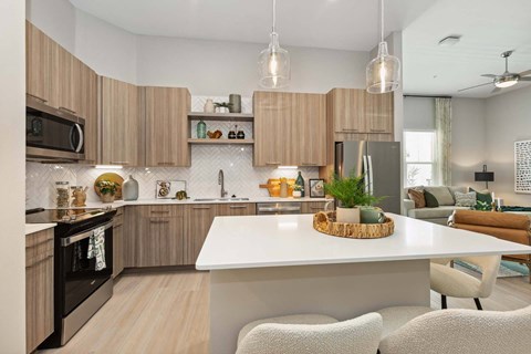 A modern kitchen with wooden cabinets and a white island.