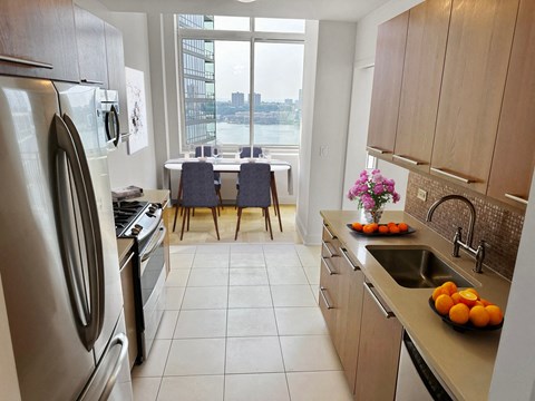 a kitchen with a large window and a sink and a refrigerator