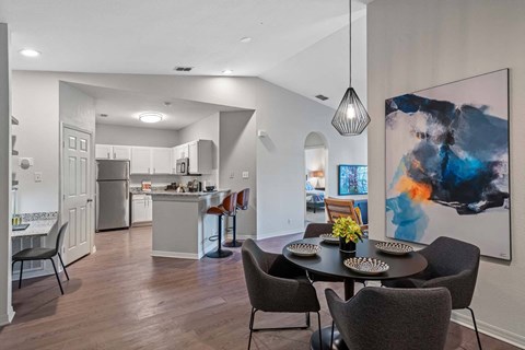 an open kitchen and dining room with a table and chairs