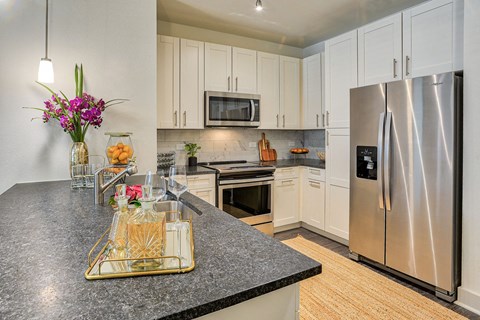 a kitchen with stainless steel appliances and granite counter tops
