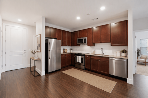 A kitchen with wooden cabinets and stainless steel appliances.