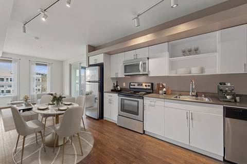 A modern kitchen with a dining table and chairs.