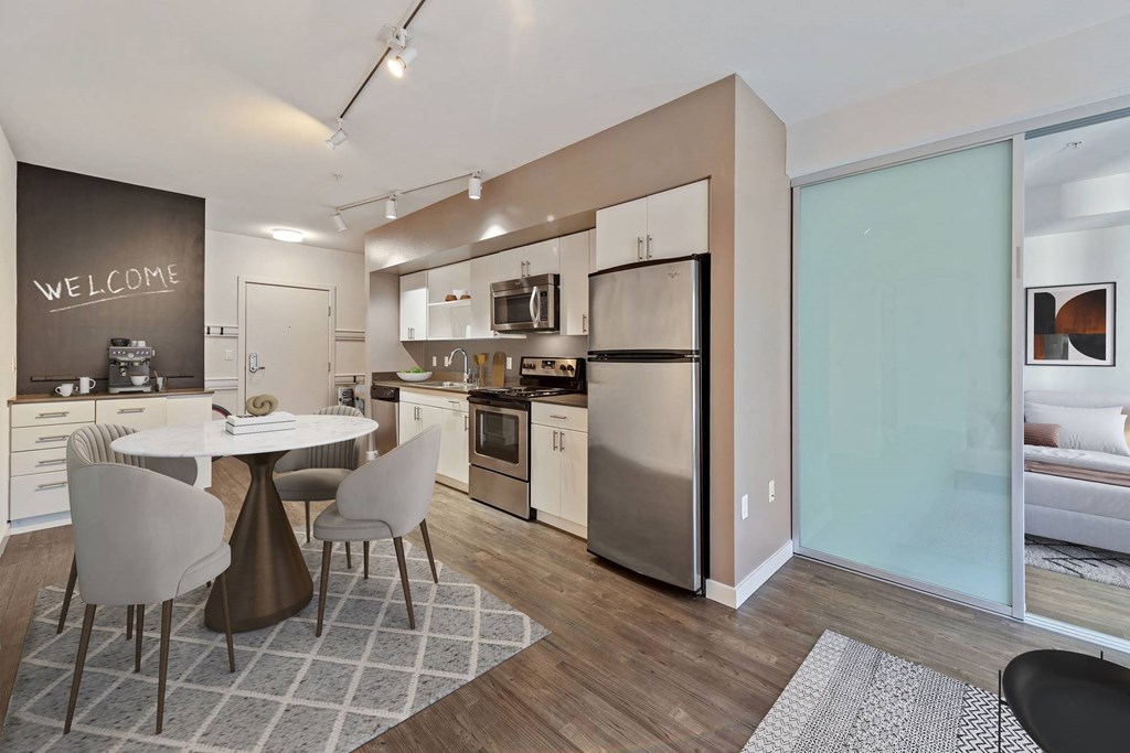 A modern kitchen with a dining table set up.