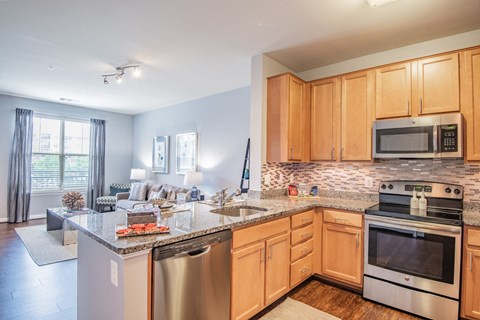 a kitchen with wooden cabinets and stainless steel appliances