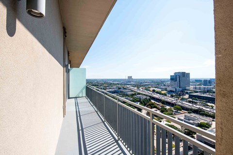 A balcony with a view of the city at the Jordan by Windsor, Dallas Texas