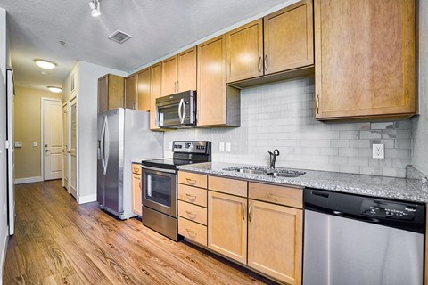 a kitchen with stainless steel appliances and wooden cabinets