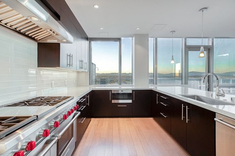 a kitchen with a large window and a stove and sink