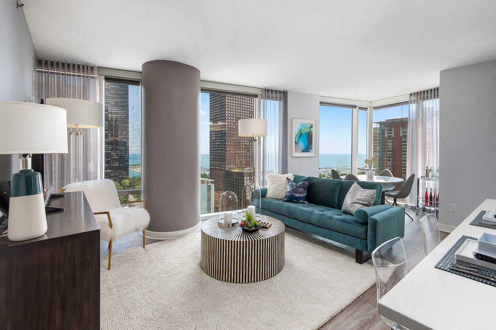 a living room with a turquoise couch and a table