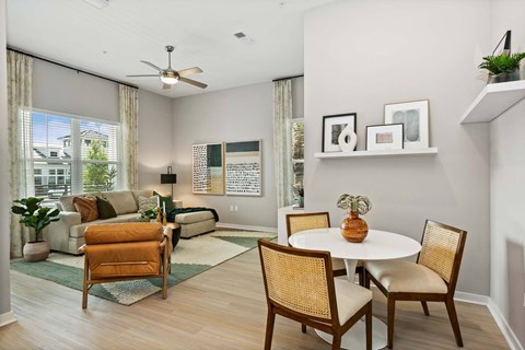 A living room with a white table and chairs.
