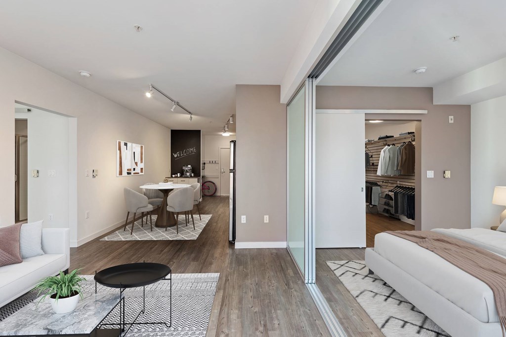 A modern living room with a dining area and a bedroom.