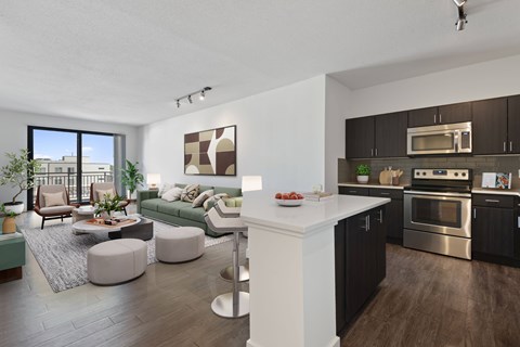 A spacious kitchen with wooden floors and white walls at Windsor Riverfront Park, Denver, 80202