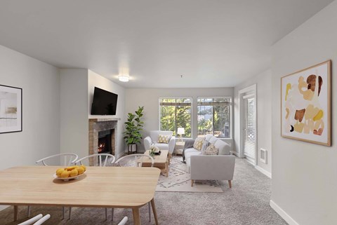 A modern living room with a fireplace and a dining table set for two.