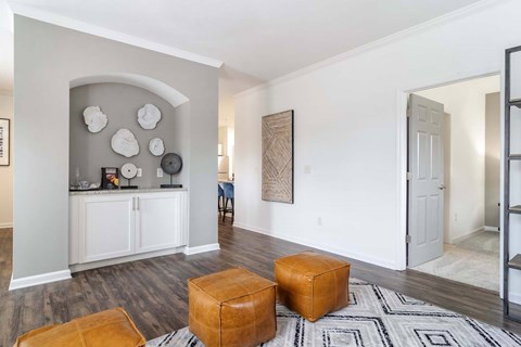 A living room with a white cabinet and a rug on the floor.