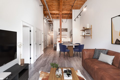 a living room and dining area with a couch and a table