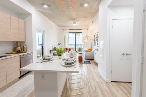 a kitchen with a marble counter top and a dining table