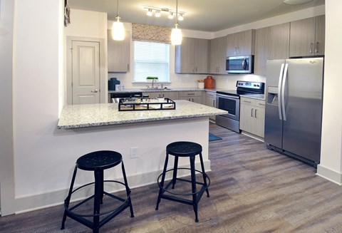 a kitchen with stainless steel appliances and granite counter tops