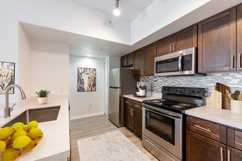 a kitchen with stainless steel appliances and wooden cabinets
