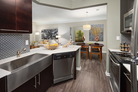 a kitchen with stainless steel appliances and a large counter top