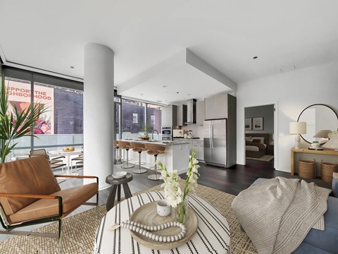 a living room with a table and chairs and a kitchen