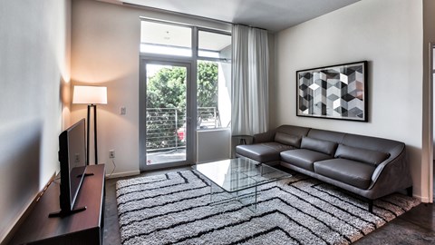 a living room with a couch and a glass coffee table