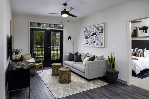 a living room with a couch and a door to a bedroom