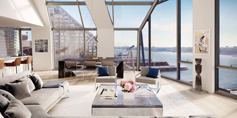 a living room with a view of the water and a couch and tables