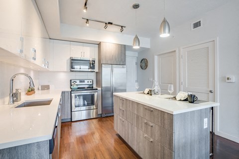 a kitchen with stainless steel appliances and a white counter top