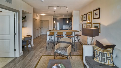 an open living room and kitchen with a dining room table and chairs