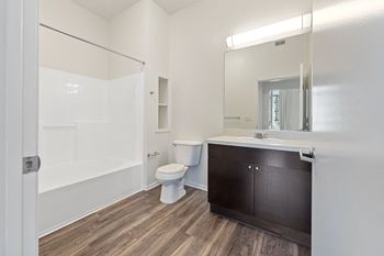 a bathroom with a toilet sink and shower