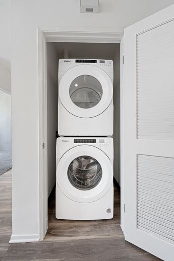 a washer and dryer stacked on top of each other in a laundry room