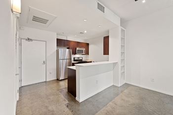 a kitchen with white walls and stainless steel appliances