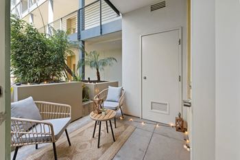 a patio with two chairs and a small table