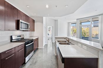 a kitchen with white countertops and wooden cabinets