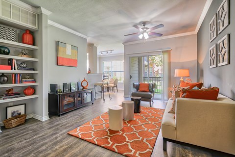 a living room with a couch and a ceiling fan