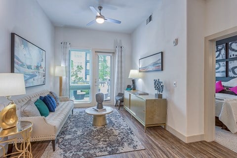 a living room with a couch and a ceiling fan