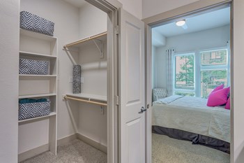 Walk-in closets with custom shelving at Metro West, Plano, TX - Photo Gallery 9