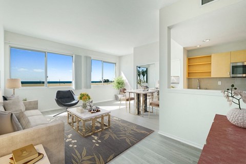 a living room with a couch and a table    and a dining room