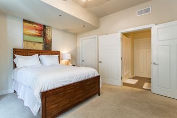 Generous bedrooms with plush carpeting that accommodate king-size beds and ceiling fans with decorative lighting