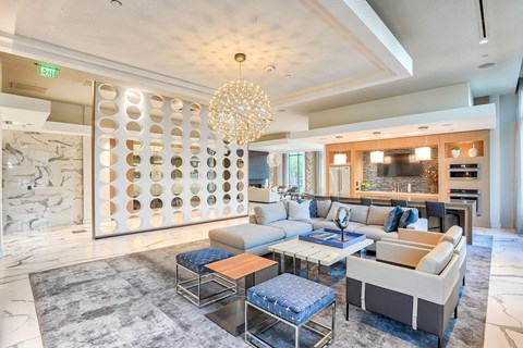 a living room with blue and white furniture and a chandelier