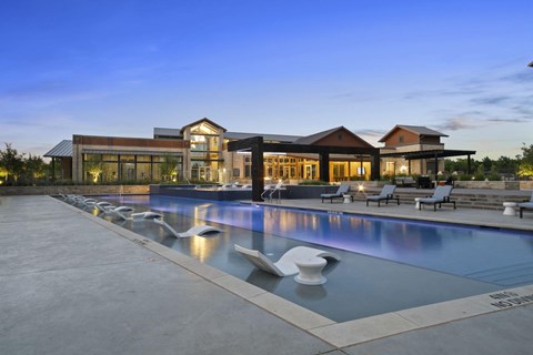 Resort style pool with seating at Windsor Lakeyard District, an apartment community in North Dallas