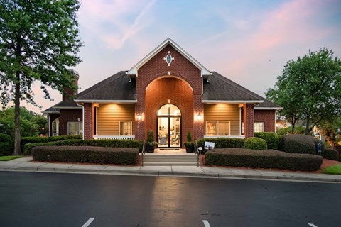 the front of a house with a street in front of it